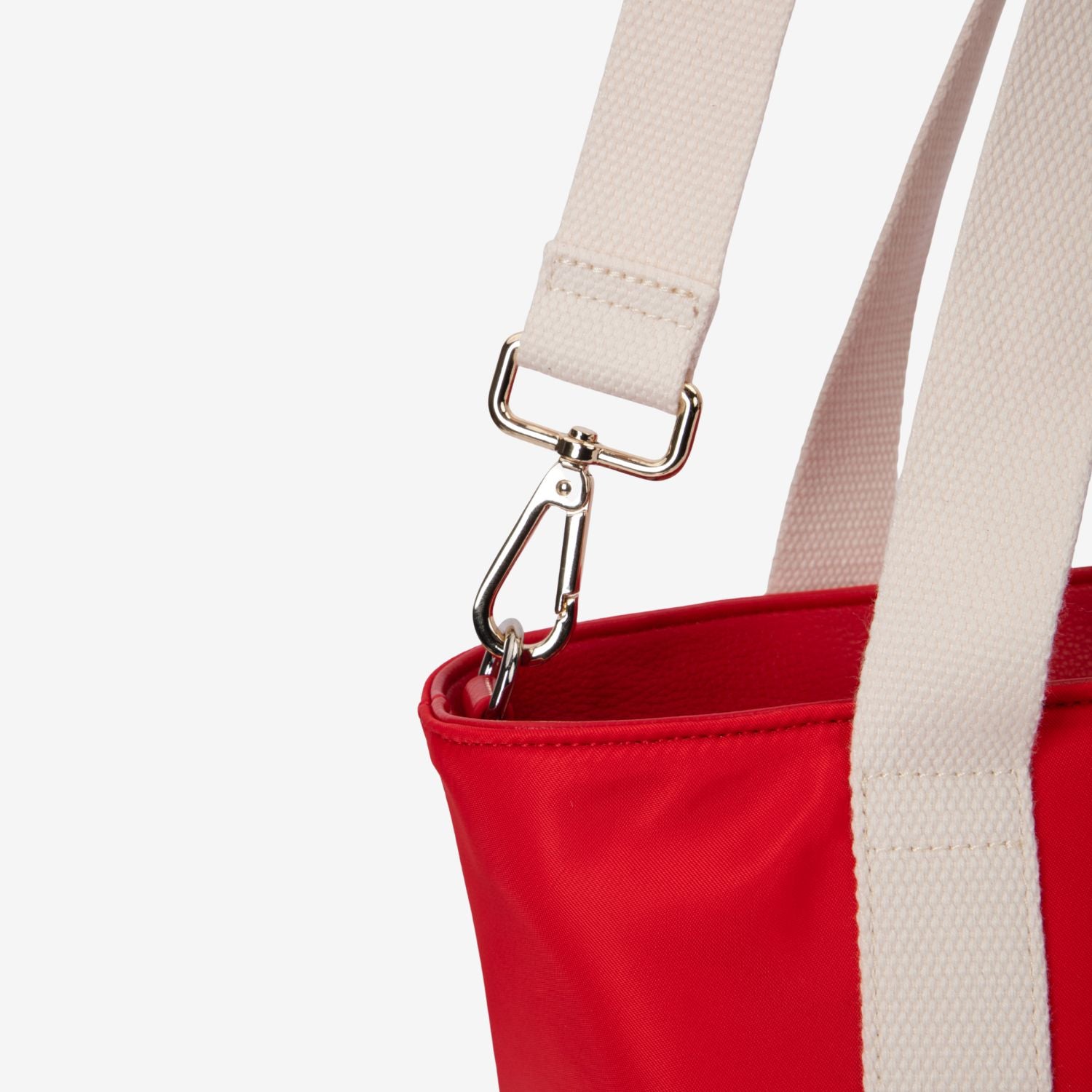 Red nappy tote bag with a beige strap and silver clasp on a white background