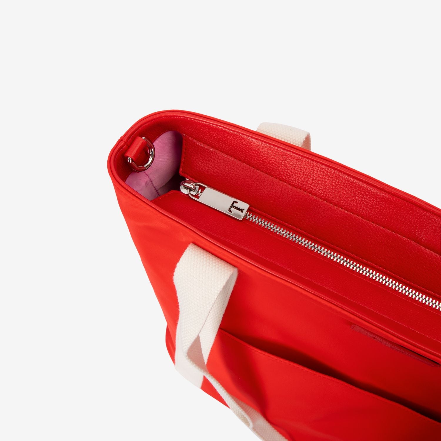 Red tote nappy bag with pink interior and handle on a white background