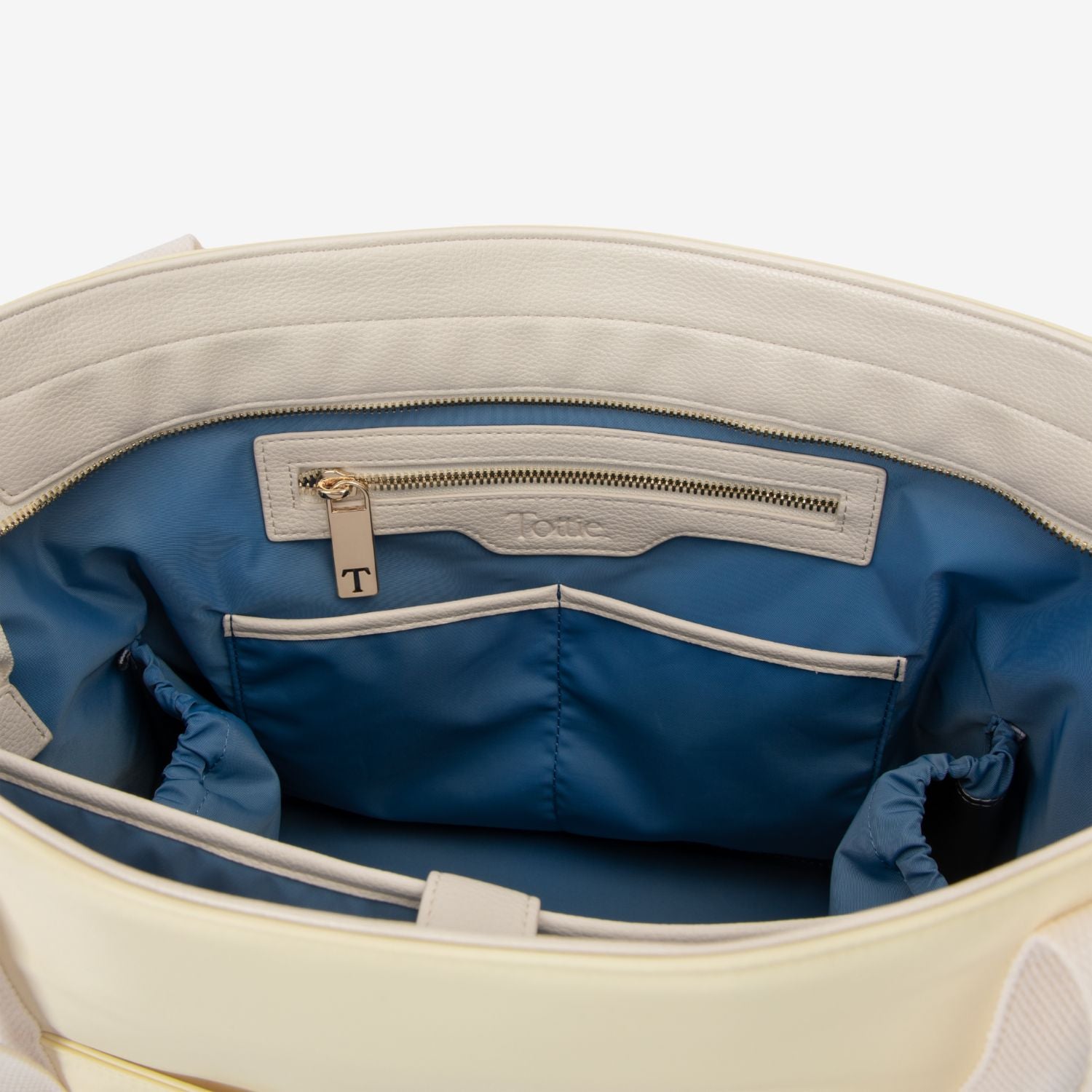 Open yellow tote bag with blue interior and visible Tottie logo.