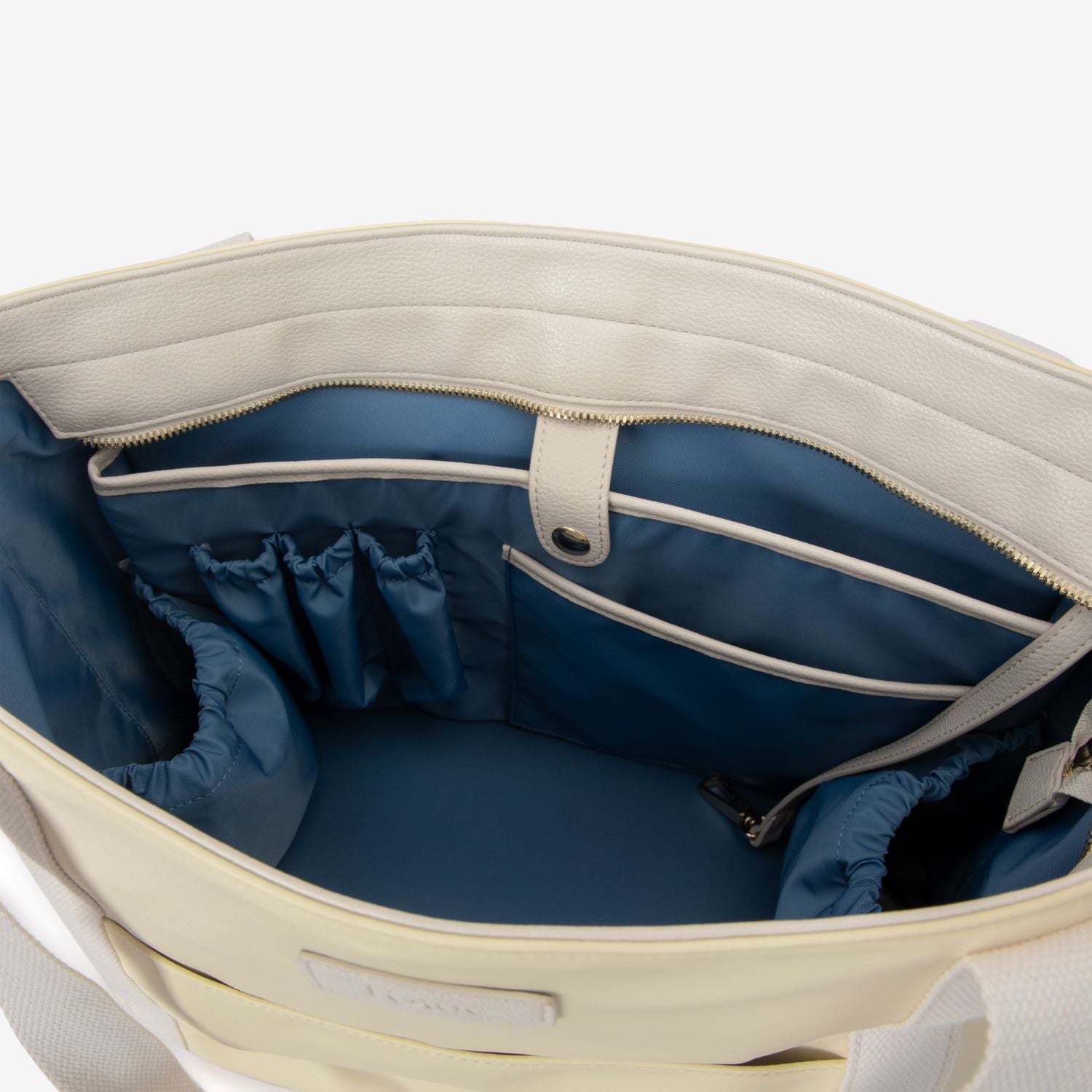 Open pastel yellow nylon tote bag with blue interior on a white background