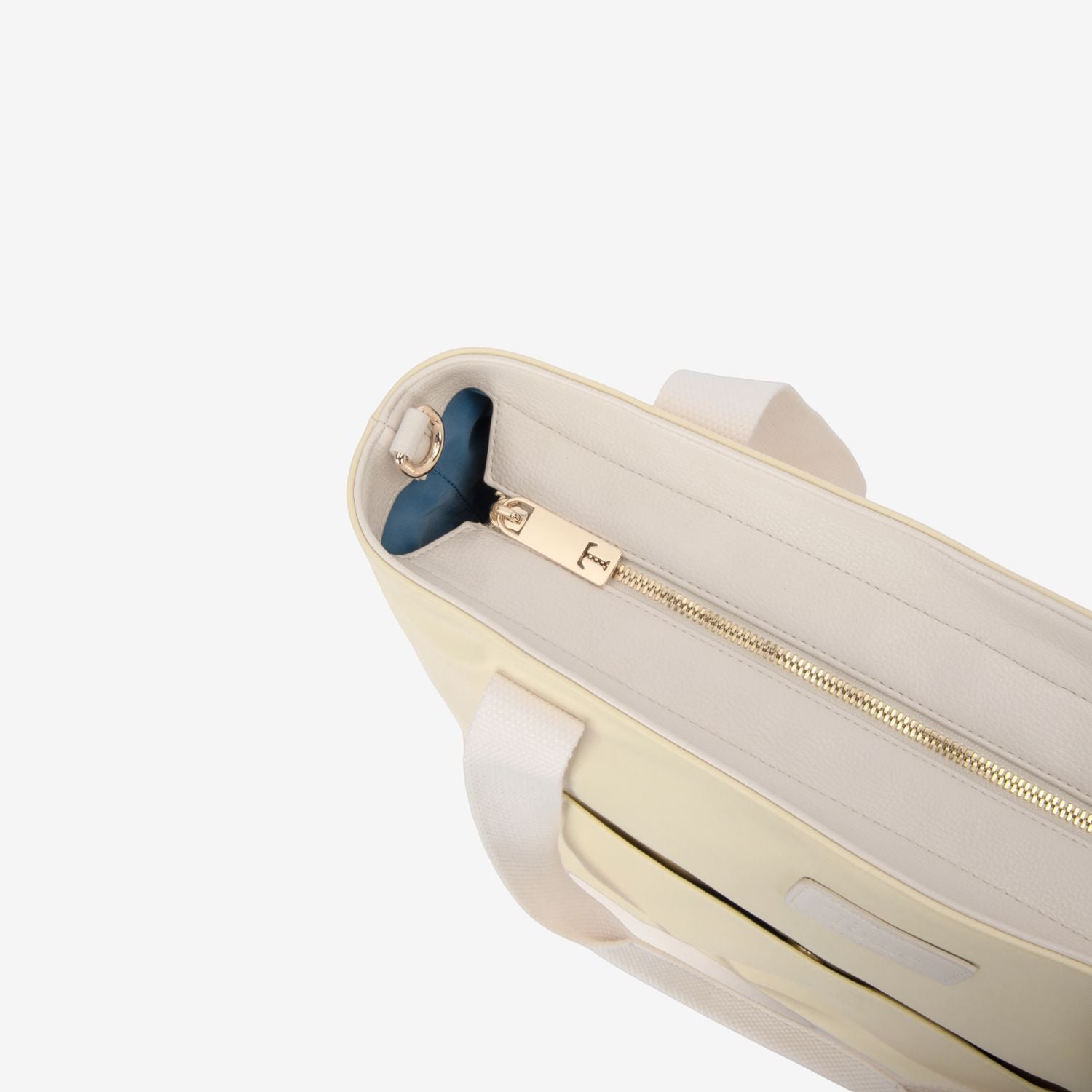 Close-up of a yellow tote nappy bag with a gold zipper and blue handle on a white background