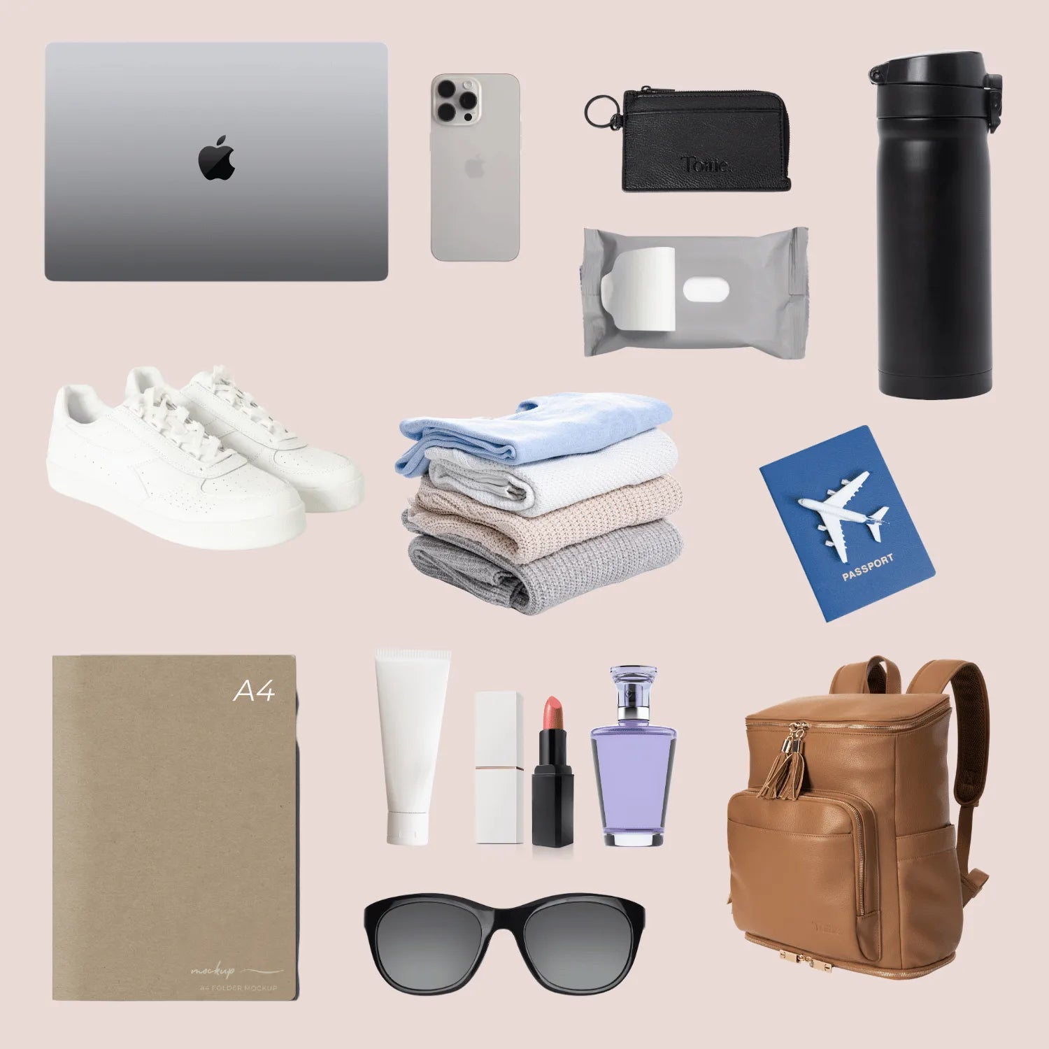 Tan-coloured work backpack with gold hardware surrounded by daily work and travel essentials – notebook, shoes, passport, and perfumes.