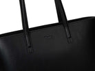 A black leather tote bag on white background
