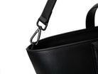 A black leather tote bag on white background