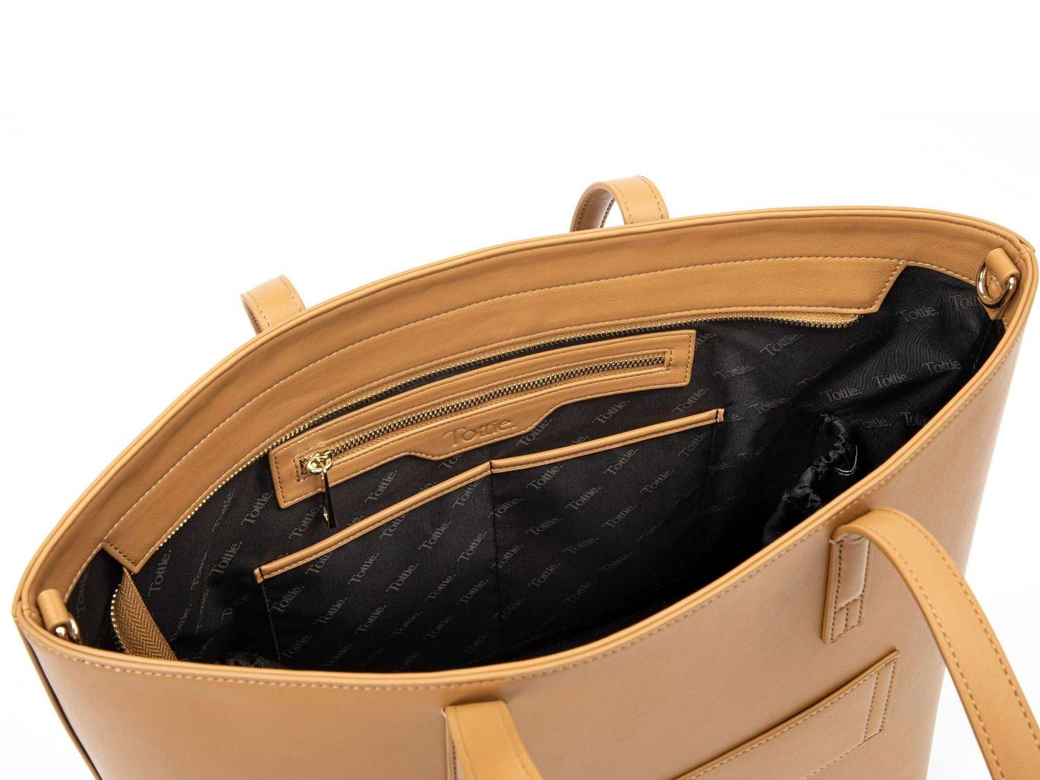 unzipped tan colour leather tote bag on white background