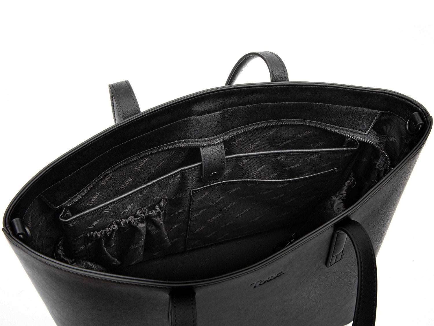 unzipped black leather tote bag on white background