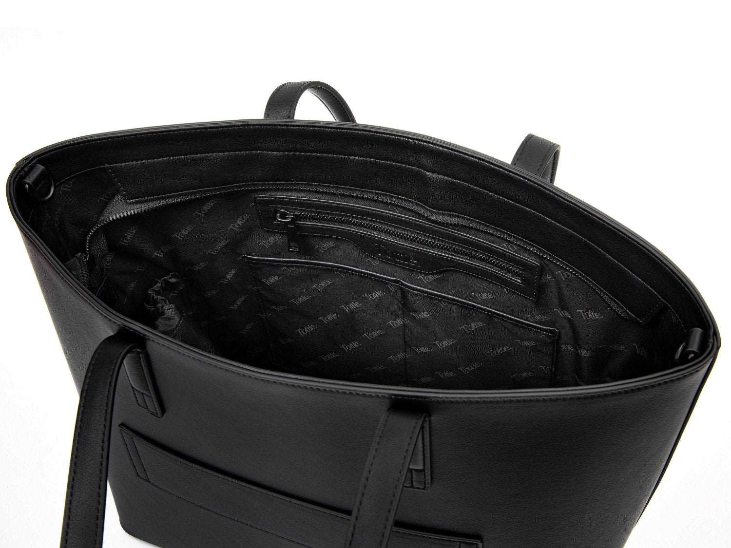 unzipped black leather tote bag on white background