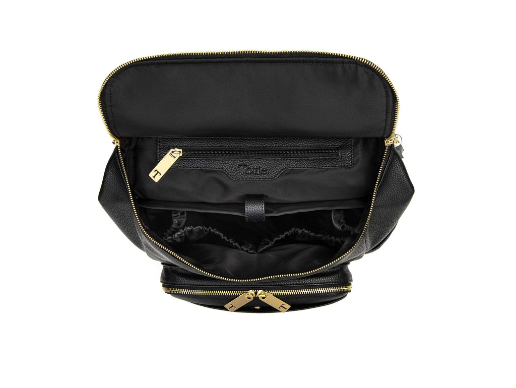 unzipped black backpack with gold hardware on white background