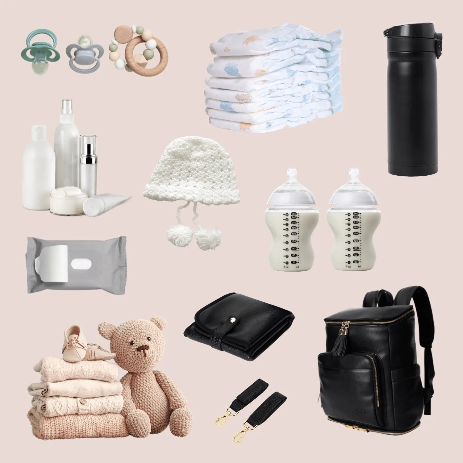 Inside a black nappy bag backpack with gold hardware: black baby change mat with gold accents, pram clips, baby essentials, and toys neatly organised.