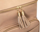 Close-up view of the stone tassel with gold hardware on a stone leather nappy backpack with a gold zipper from Tottie.