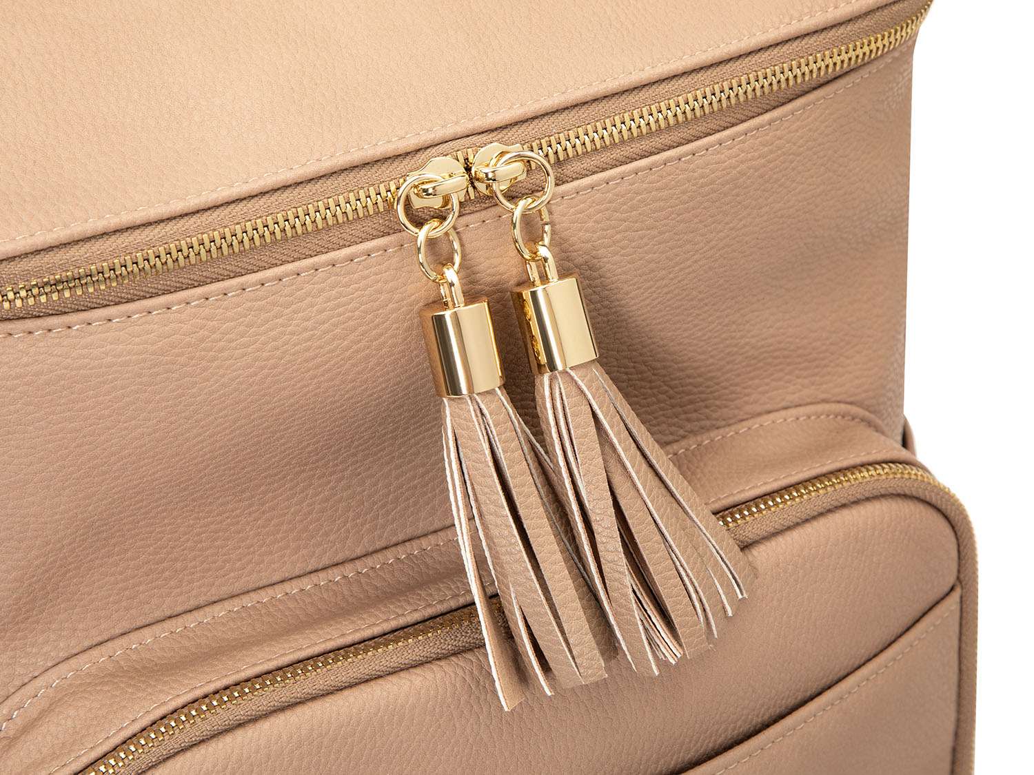 Close-up view of the stone tassel with gold hardware on a stone leather nappy backpack with a gold zipper from Tottie.