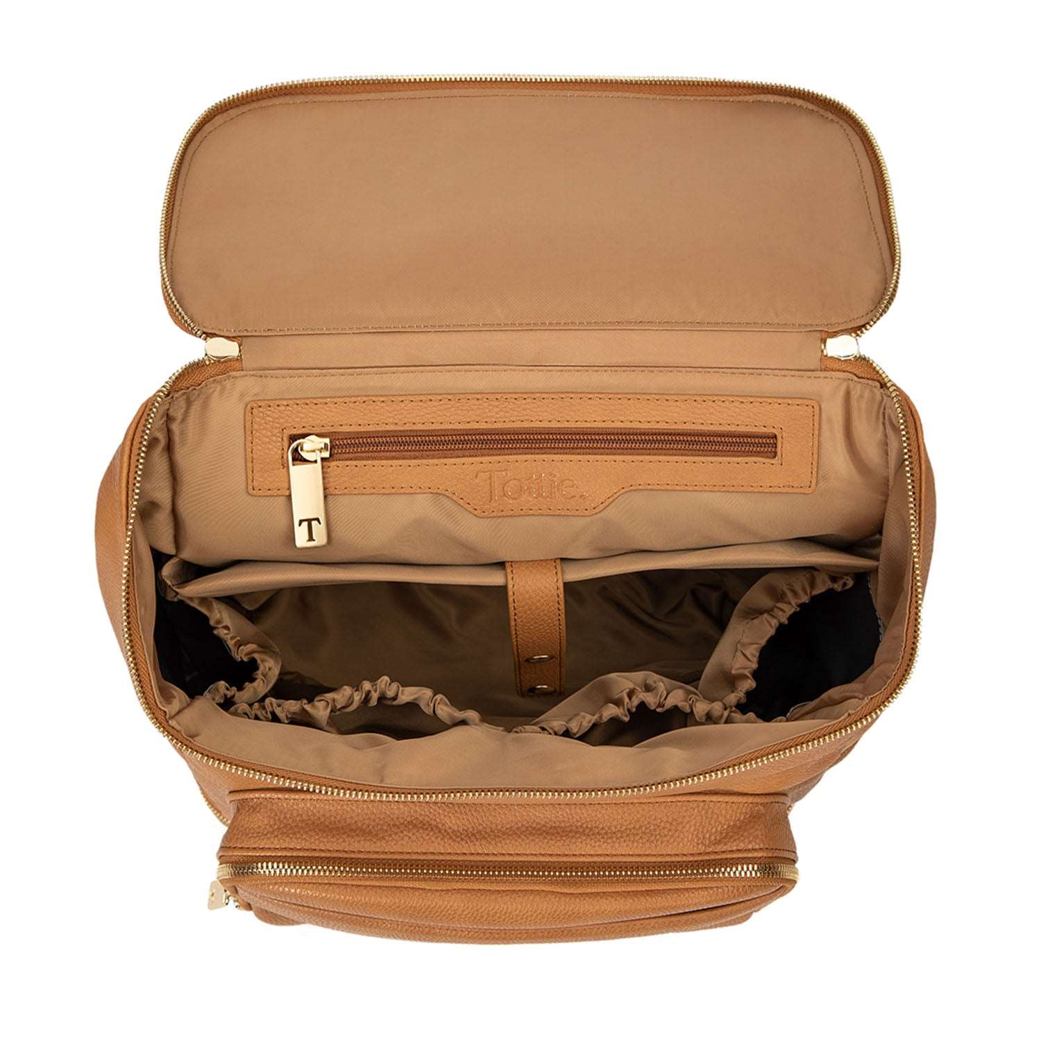 Top view of the unzipped main compartment of a tan-colored backpack from Tottie, featuring gold hardware, displayed against a white background