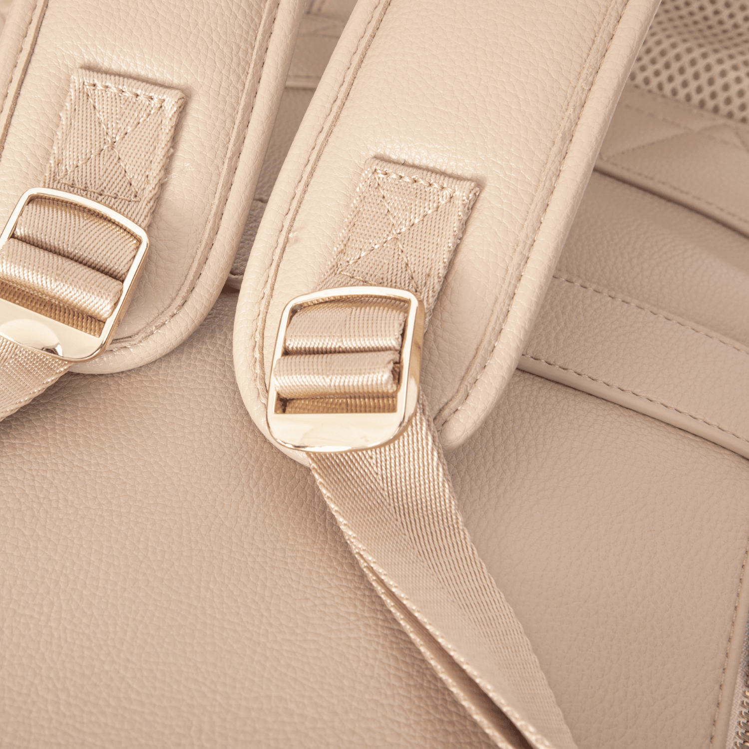 Close-up of nappy bag backpack straps with gold buckles