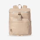 Beige travel backpack with gold zippers and tassels on a white background