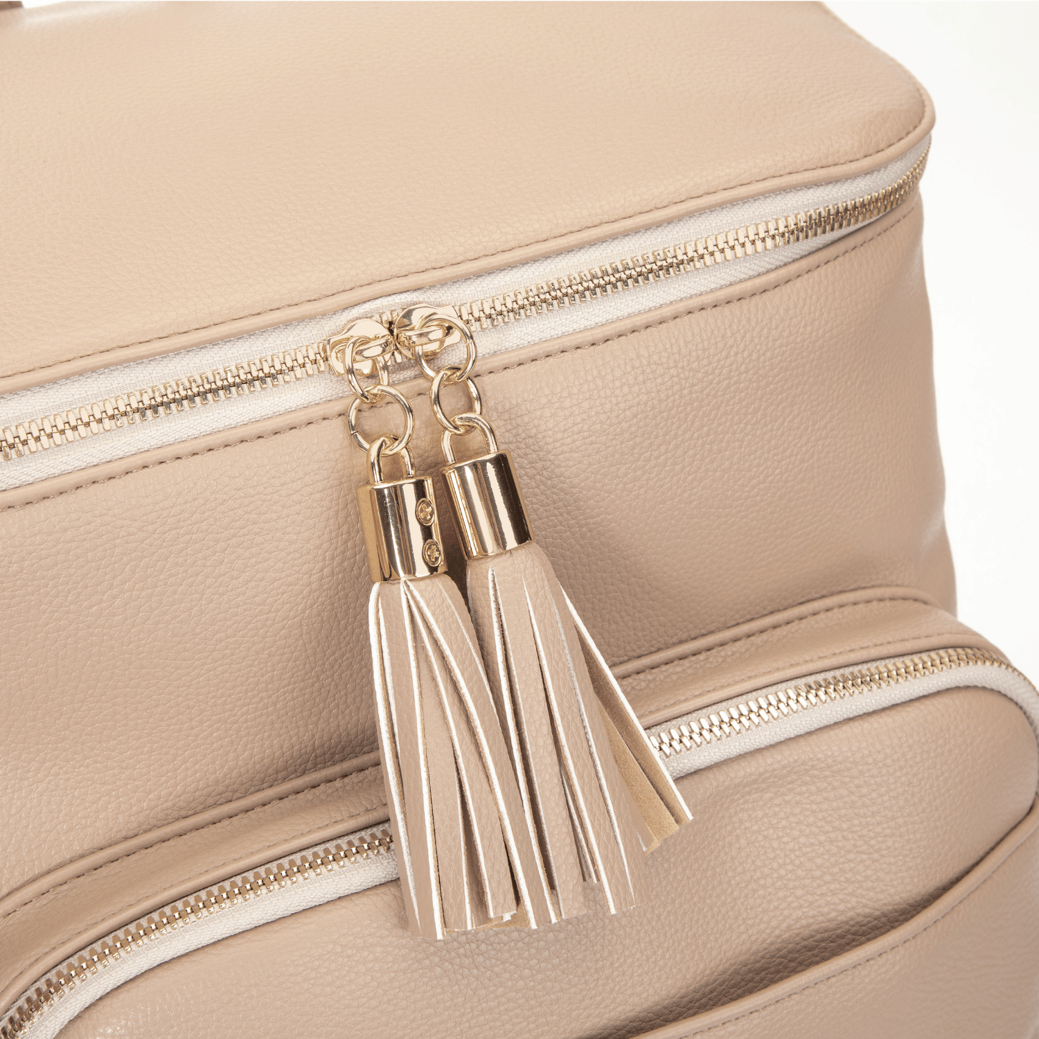 Stone travel backpack with tassel details on a white background