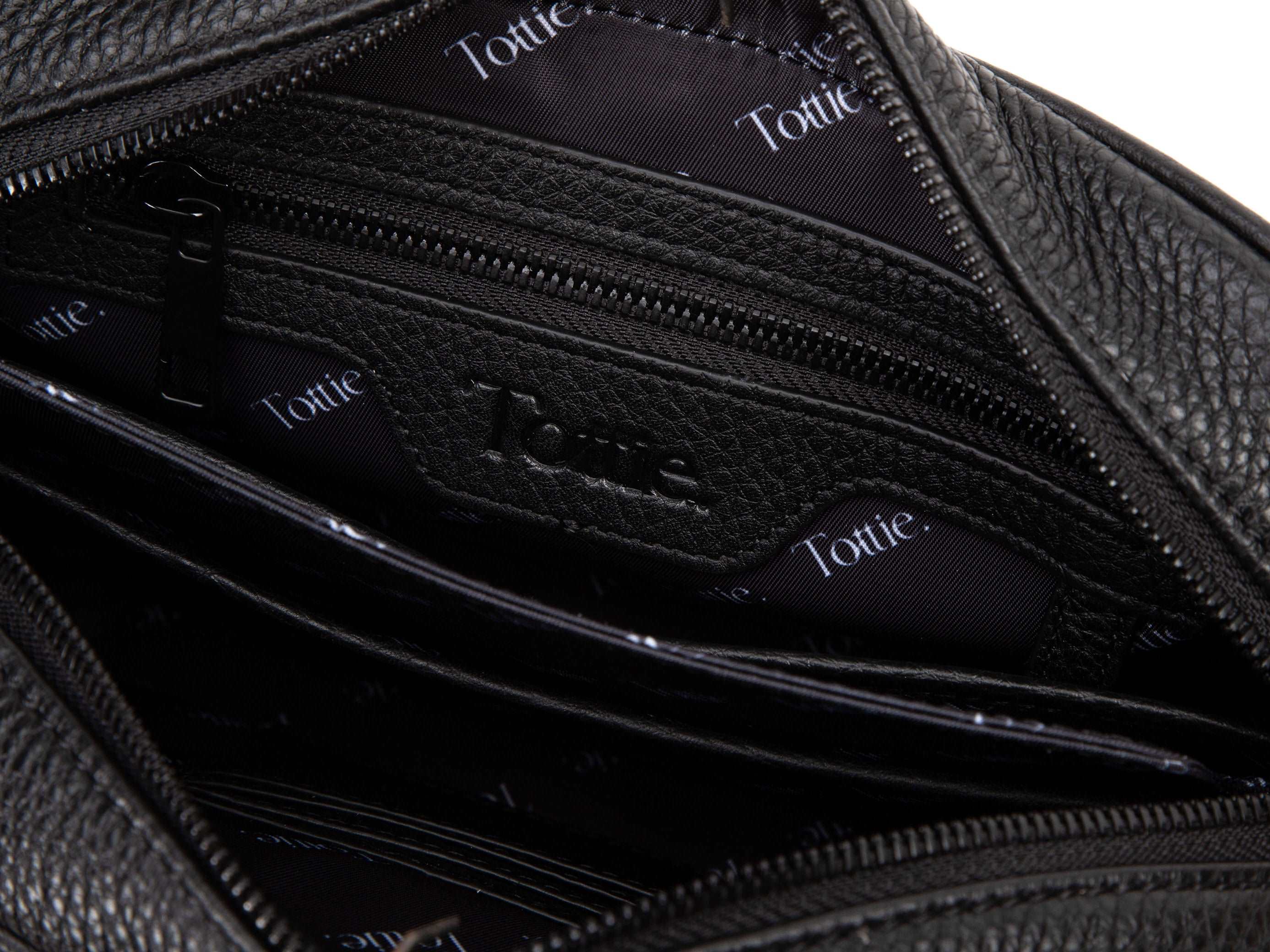 unzipped black leather crossbody bag in white background