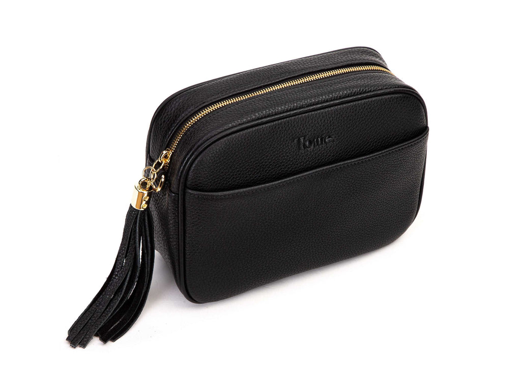 black leather crossbody bag with gold hardware in white background