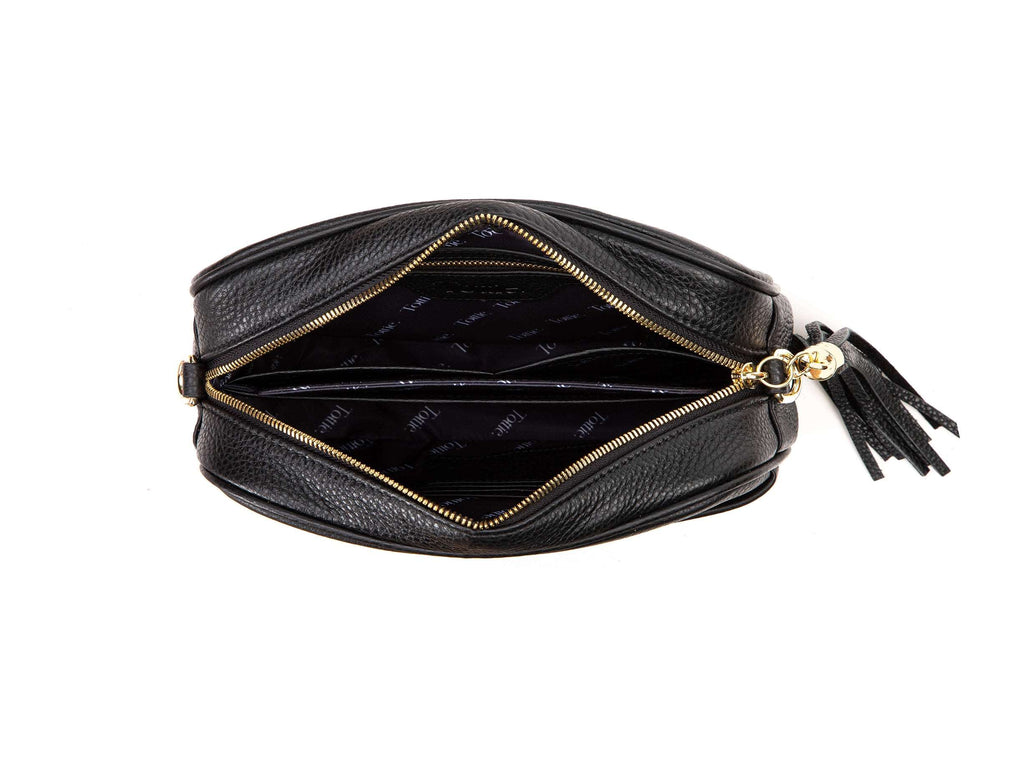 unzipped black leather crossbody bag with gold hardware in white background