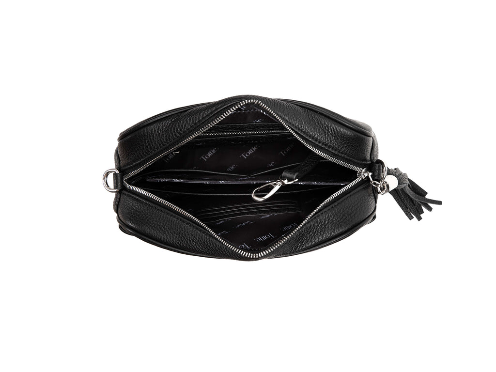 unzipped black leather crossbody bag with silver hardware in white background