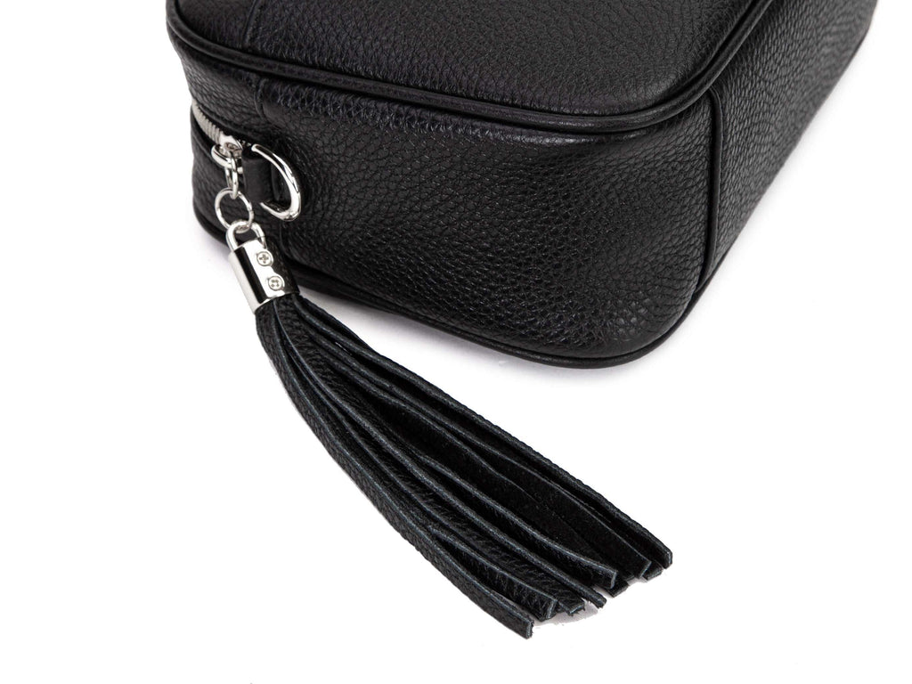 black leather crossbody bag with silver hardware in white background