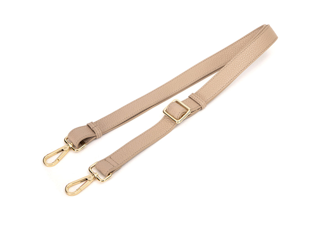 stone colored leather bag strap in white background