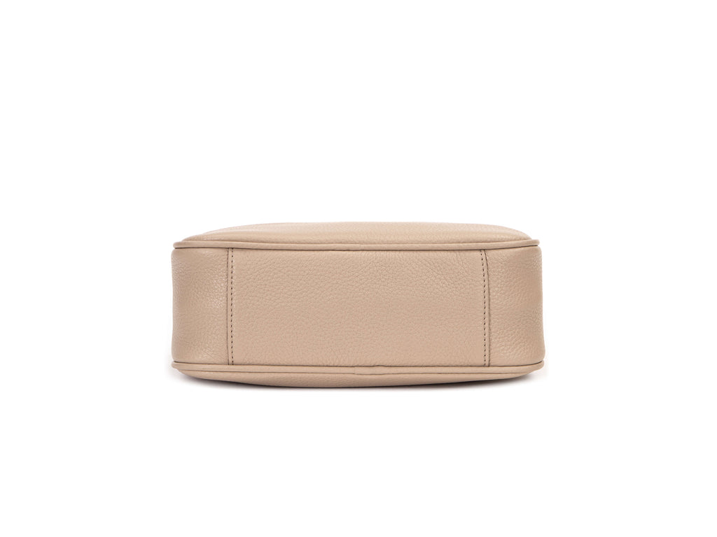 stone colored leather bag in white background