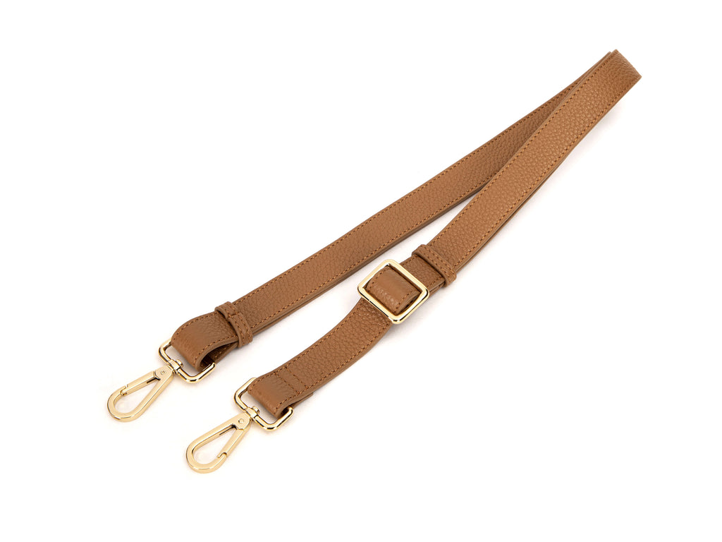 tan colored leather bag strap in white background