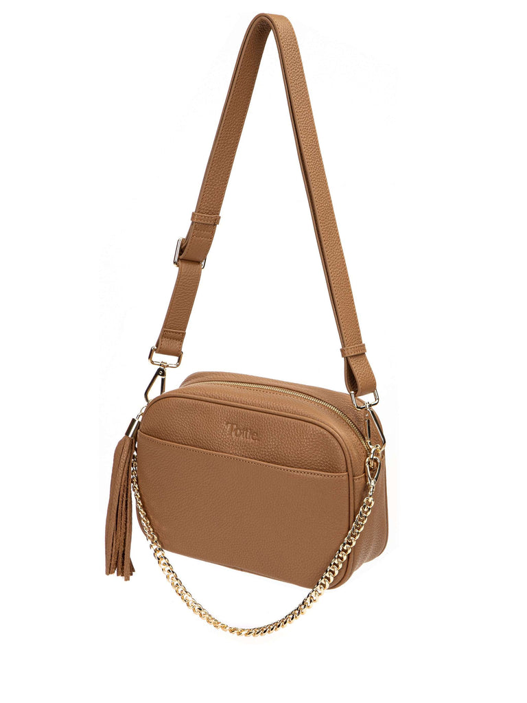 tan colored leather crossbody bag in white background