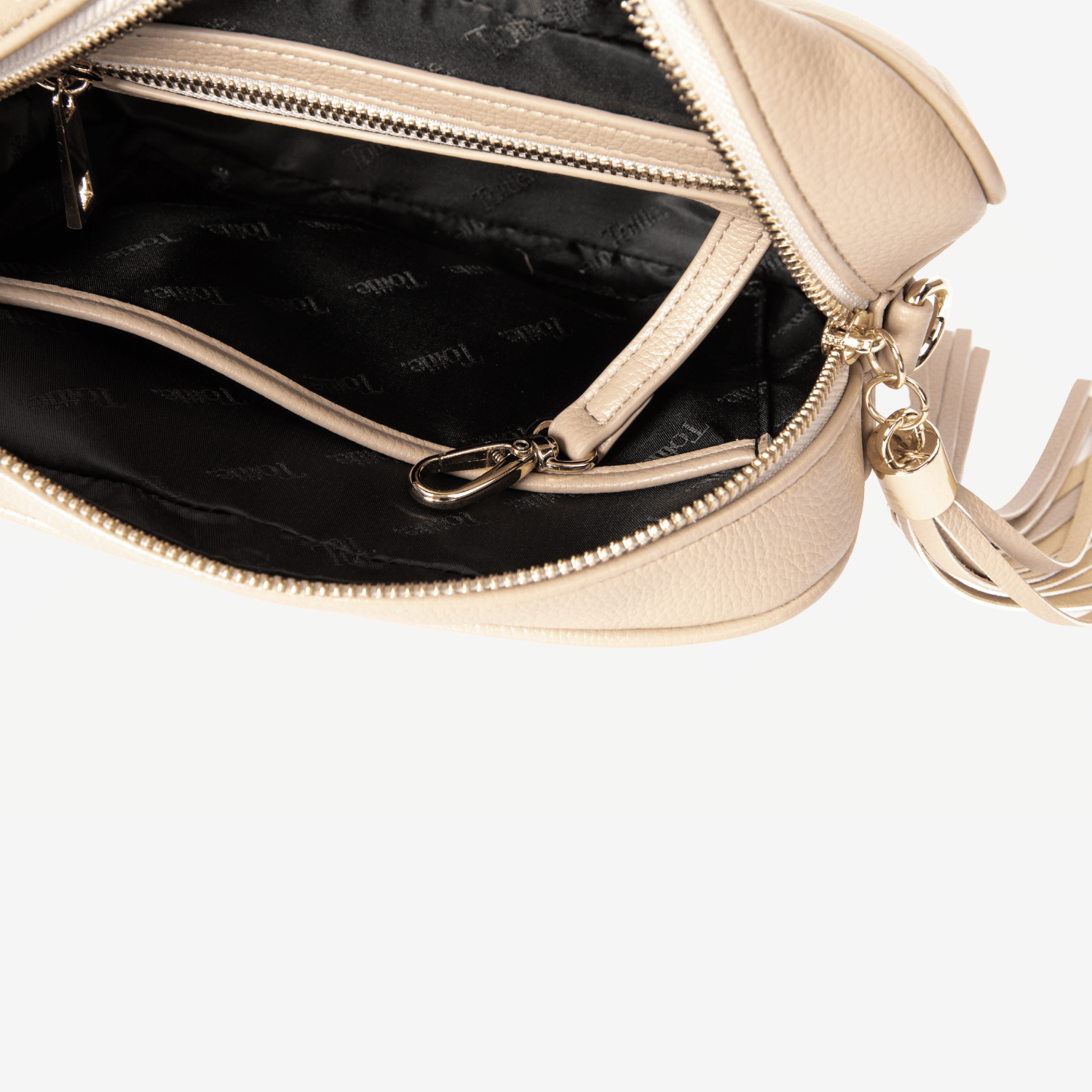 Stone crossbody bag with gold zipper and handle on a white background