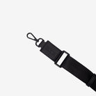 Black crossbody strap with a clip on a white background