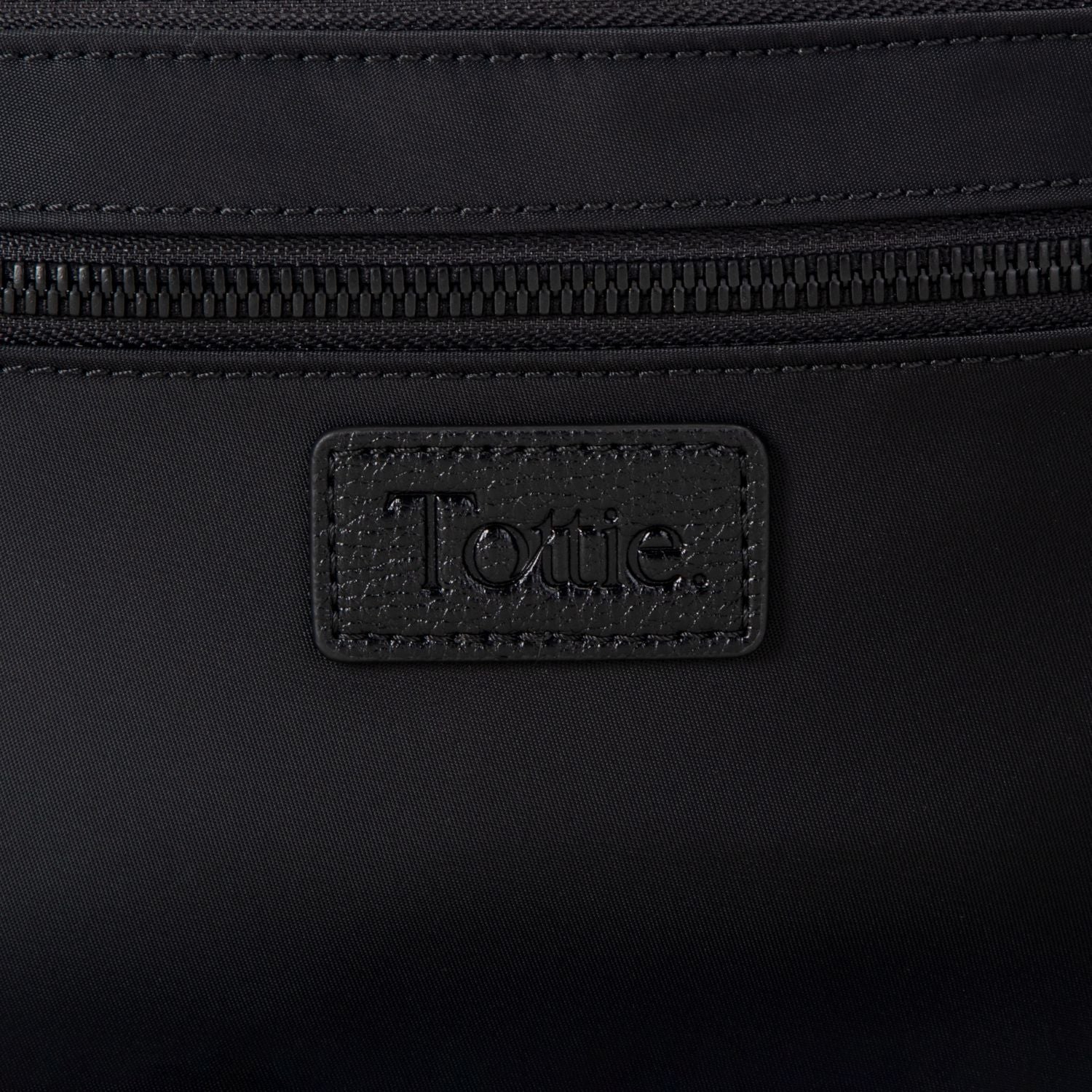 Black nylon bum bag with 'Tottie' brand logo on a black background