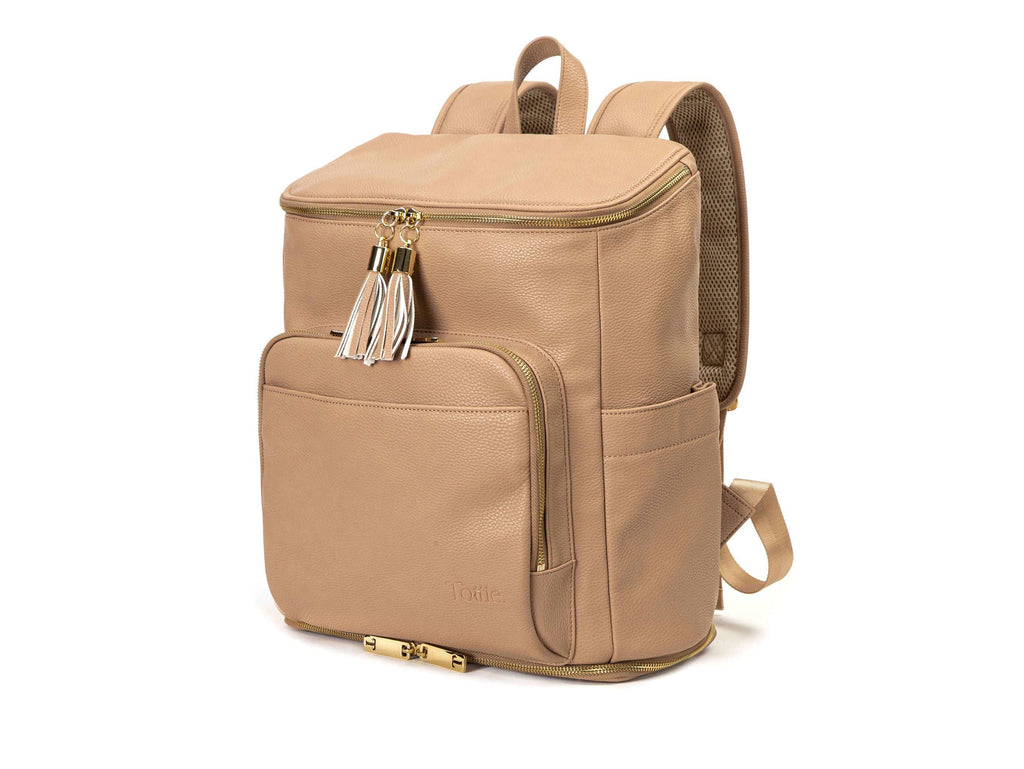 stone colored backpack with gold hardware on white background